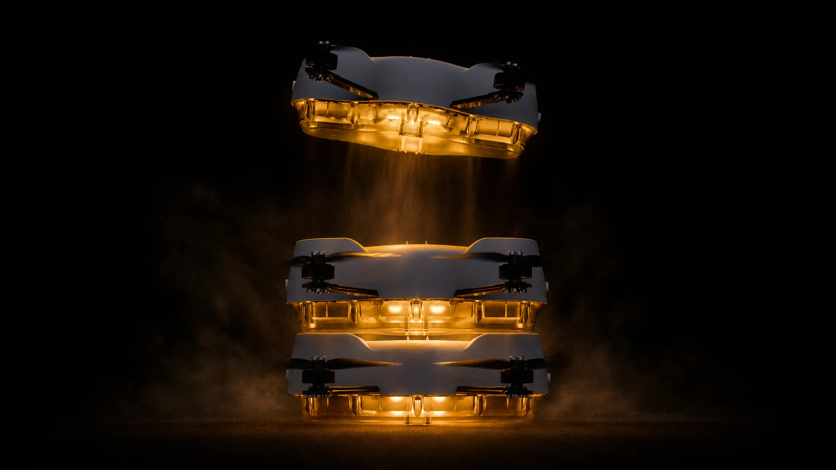 Three white Spectra drones lifting through illuminated smoke